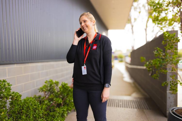 A St John worker on the phone to a client using telephone services.