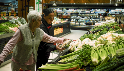 Community worker helping elderly lady do her groceries
