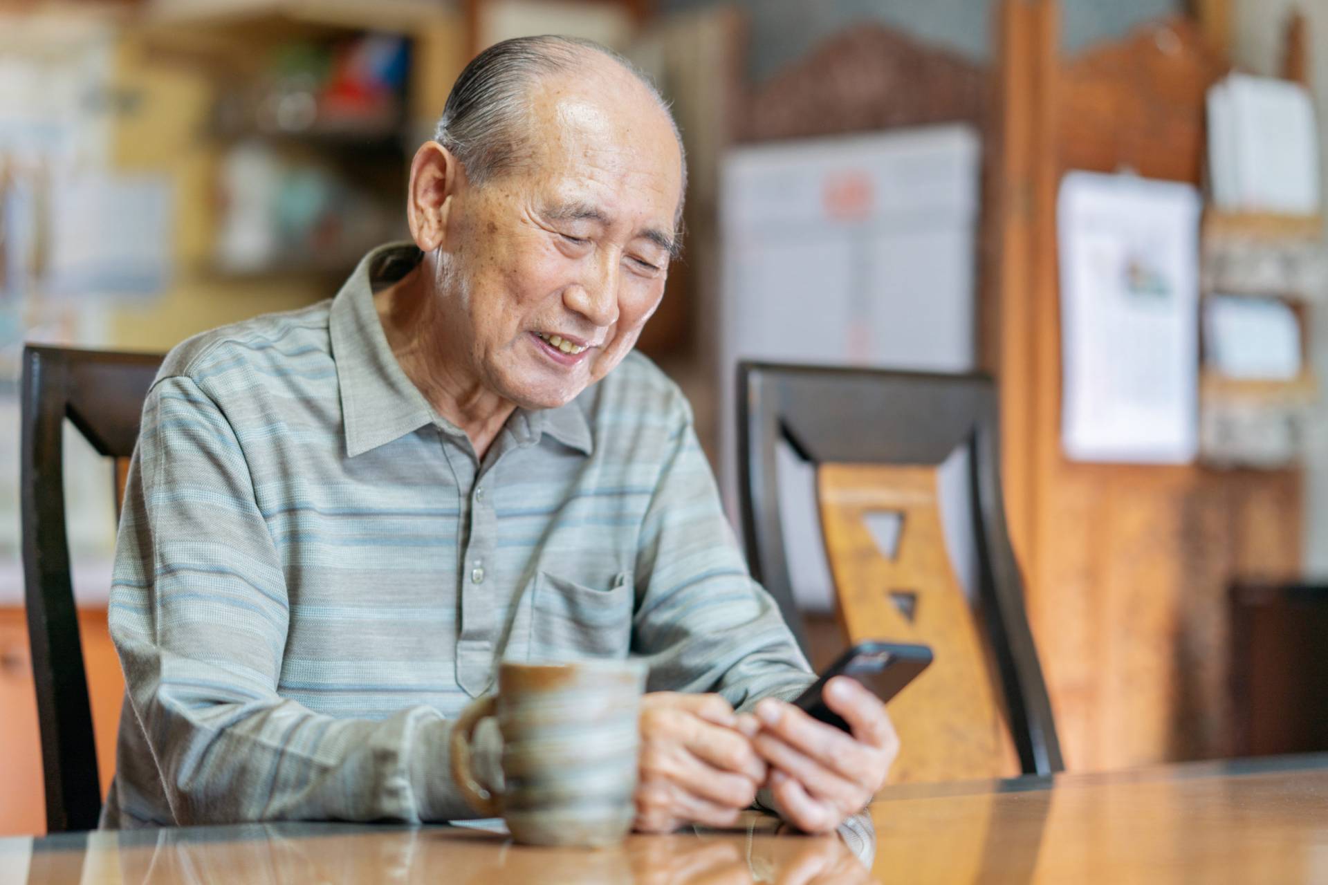 Portrait of senior man while using smart phone